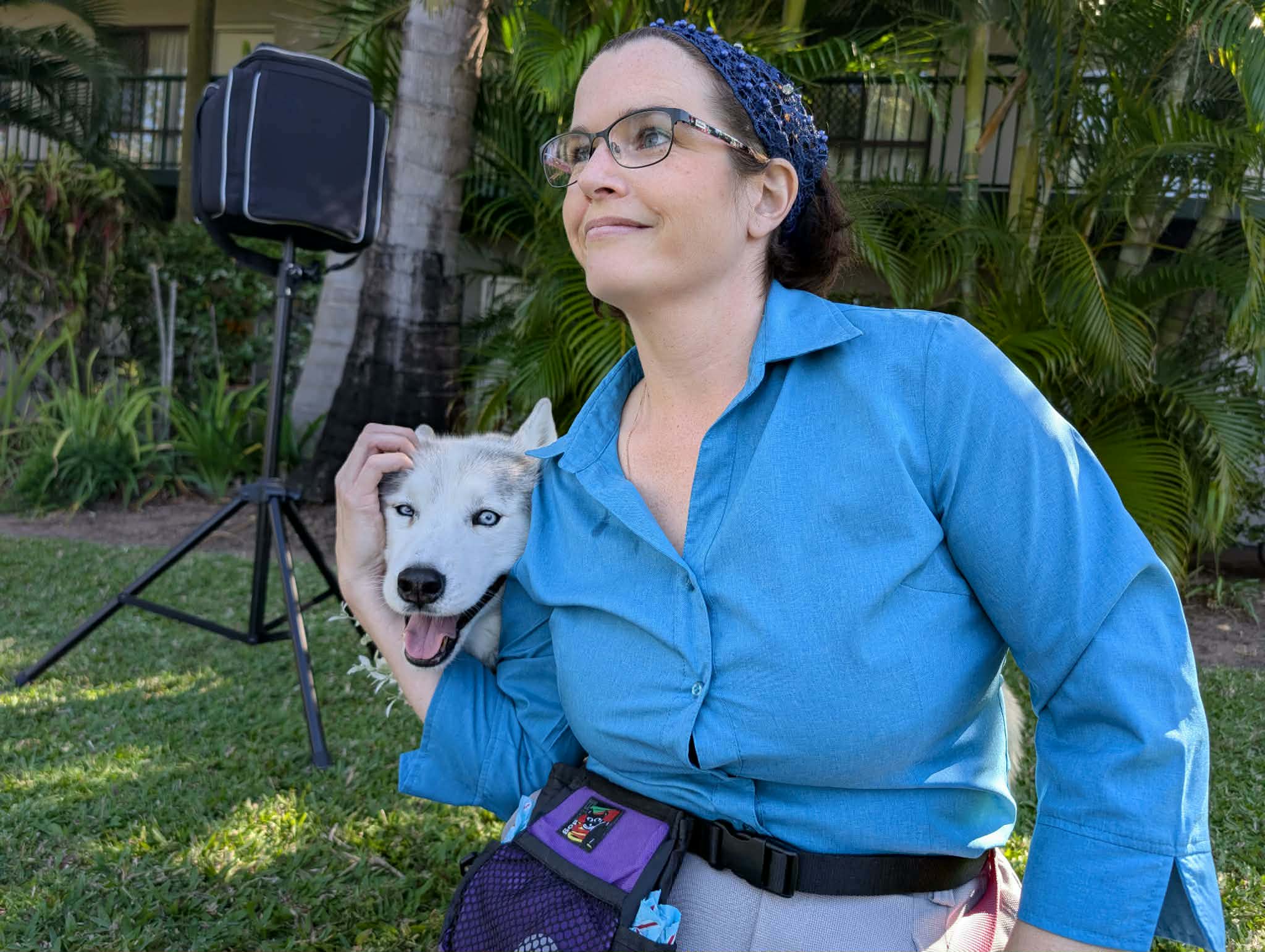 Pups of Honour handler cuddling a husky puppy in the garden
